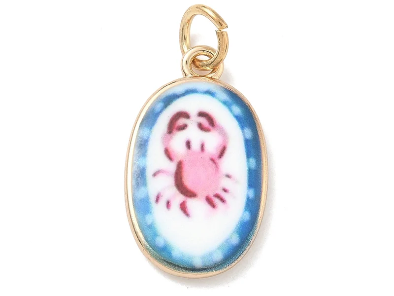 Breloque ovale motif crabe imprimée - laiton doré