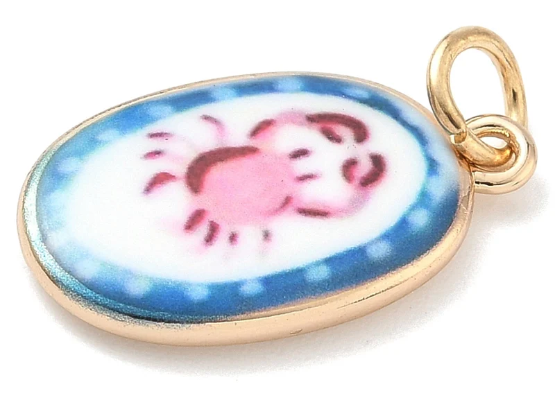 Breloque ovale motif crabe imprimée - laiton doré