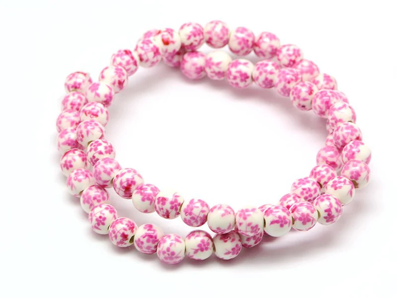 Lot de 10 perles en porcelaine - fleurs roses - 6 mm
