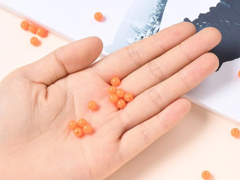 100 perles en plastique rondes 6 mm - orange fluo