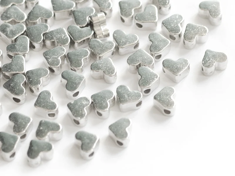 50 petites perles en plastique - cœurs argentés