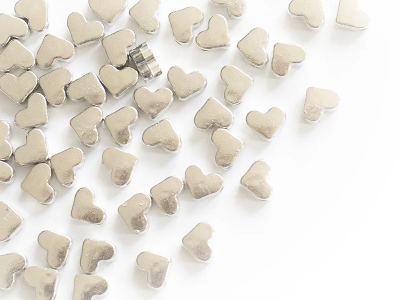 50 petites perles en plastique - cœurs argentés